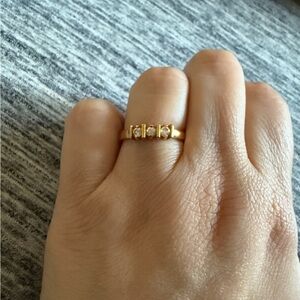 Gold tone ring with clear stones